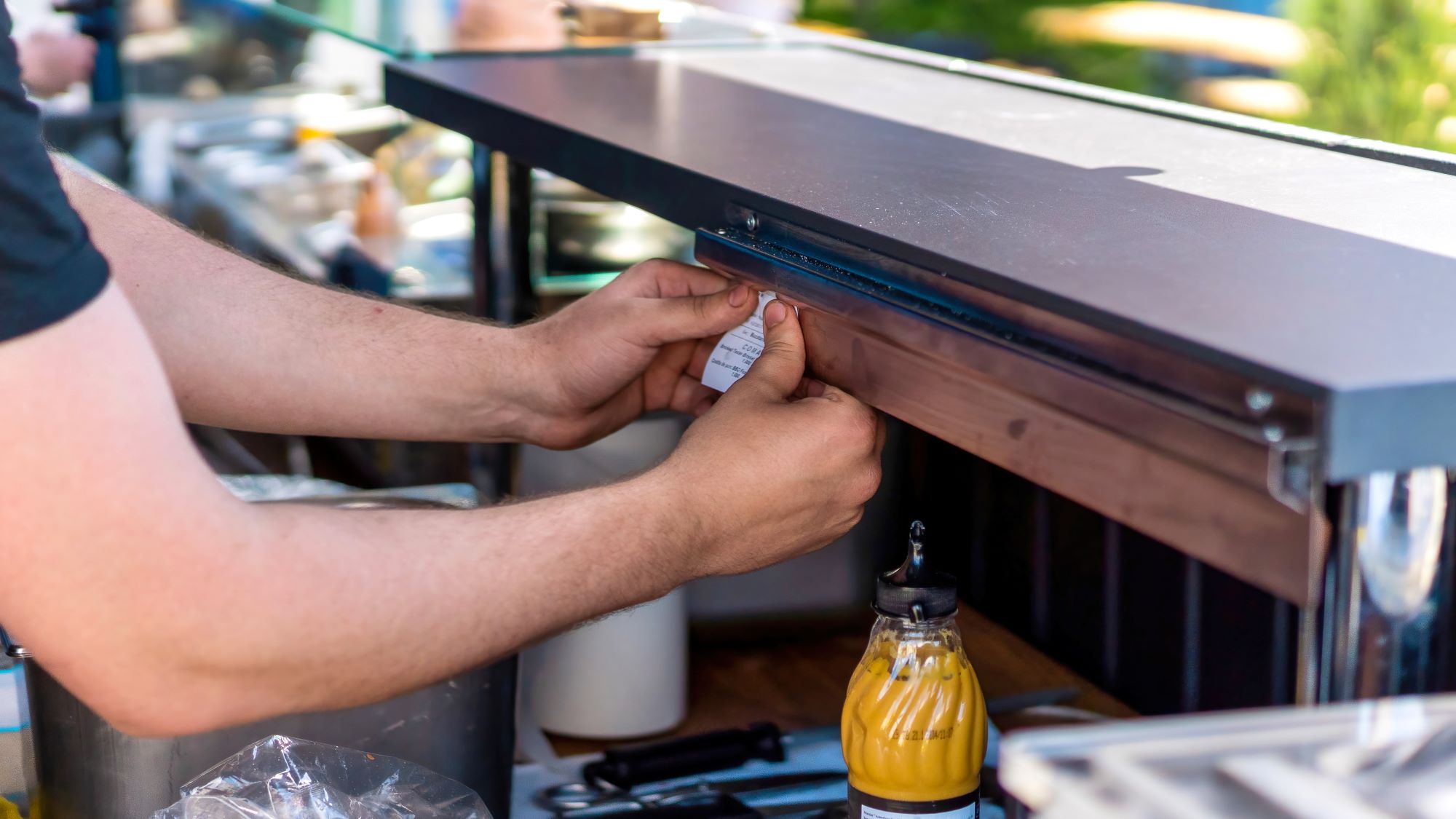 cook-pinning-the-order-paper-above-the-work-place